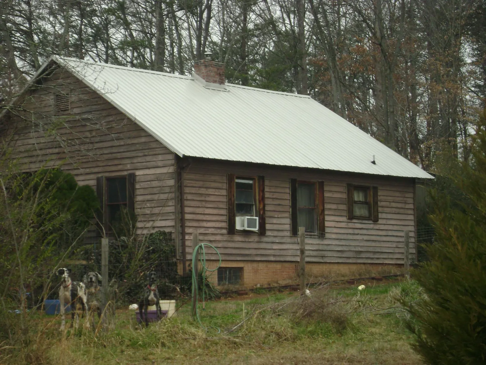 White metal roof on an old wood sided farmhouse, from a Metal Roof Installation job in East Palestine